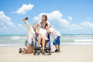 picture of disabled woman with her family on the beach